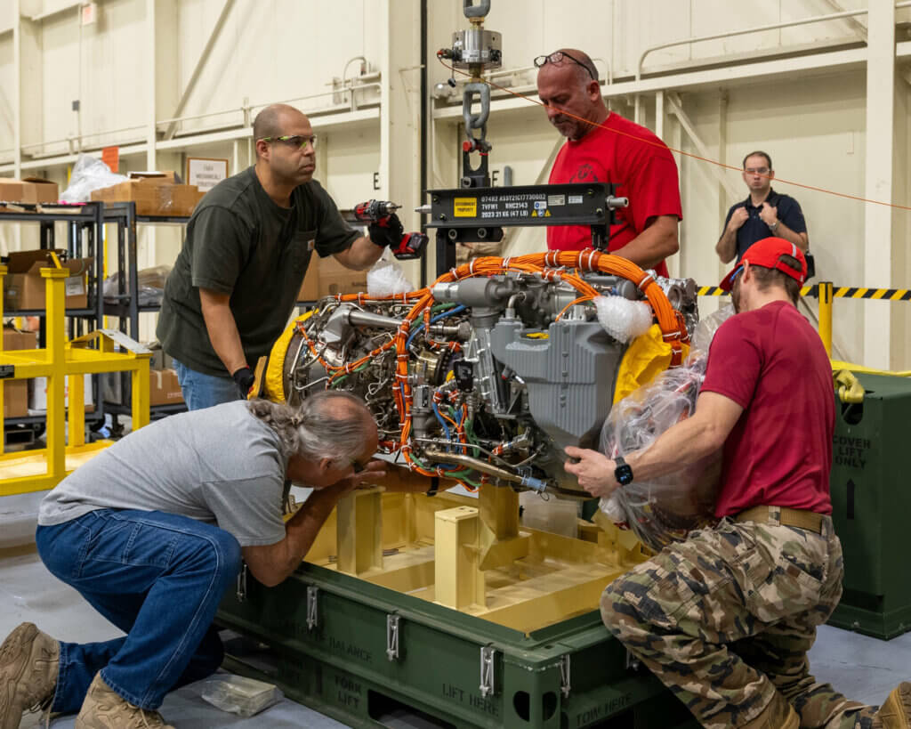 Sikorsky team members remove a recently delivered GE T901 engine from its shipping crate at the Sikorsky facility in West Palm Beach, Florida, on Oct. 20. U.S. Army Photo