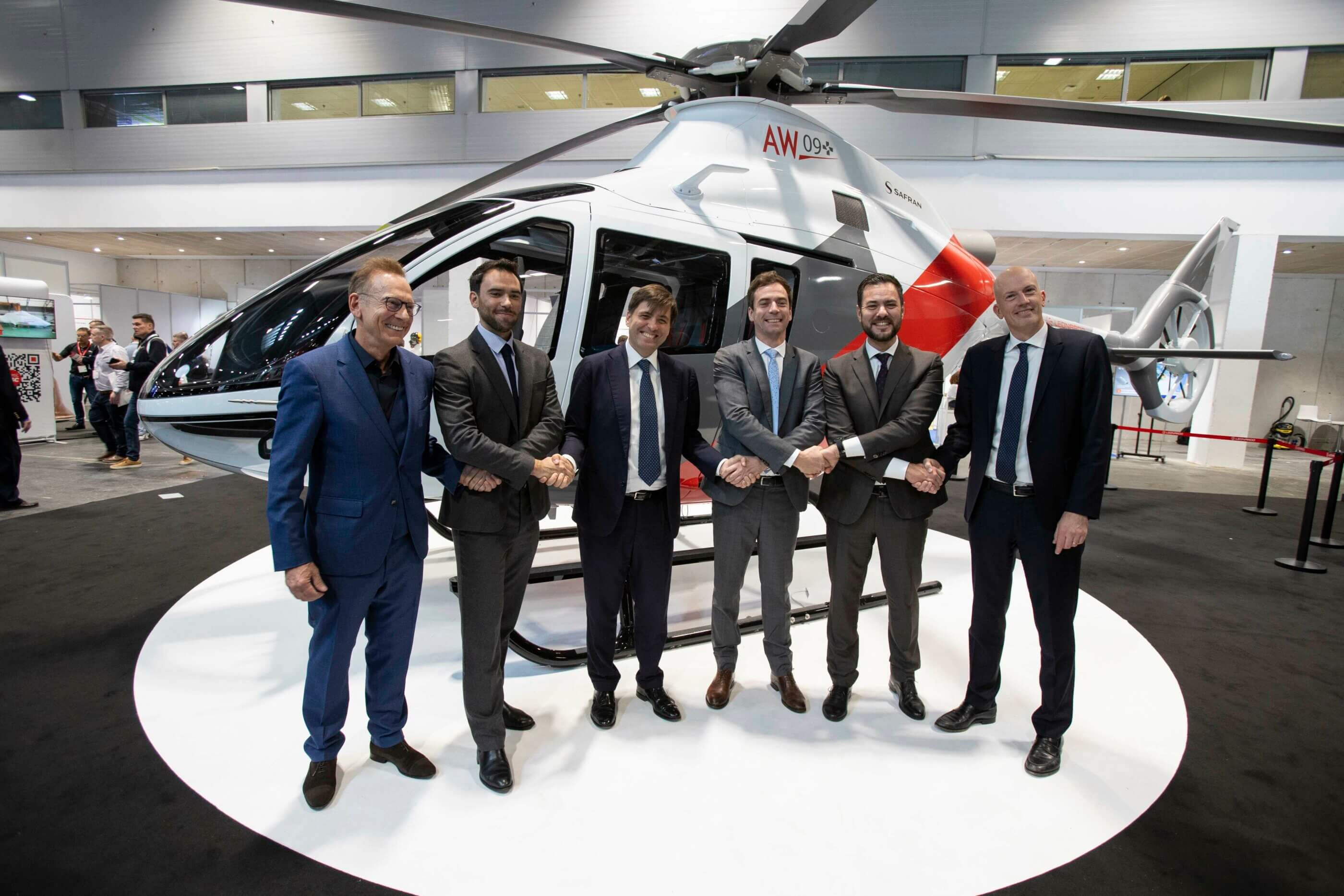 Executives from Leonardo and Léman Aviation shake hands following the announcement of preliminary sales contracts for 10 AW09s. Leonardo Photo