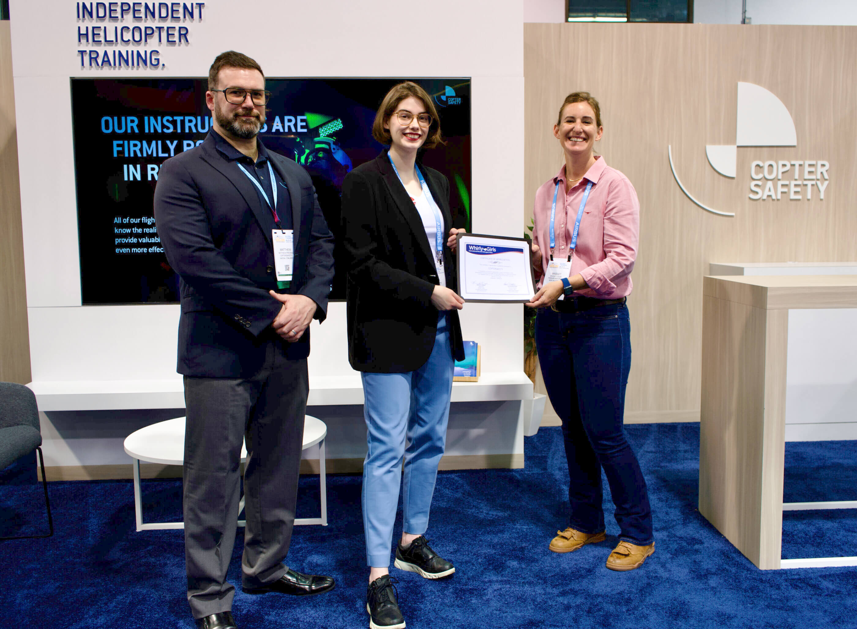 From left: Matt Presnal and Isabella Presnal from Coptersafety accept a Whirly-Girls Certificate of Appreciation from Bridget Colby of Whirly-Girls International at Heli-Expo 2024. Coptersafety Photo