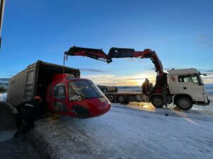 A crew from Leading Edge Aerospace loads an Airbus H125 into a shipping container. Leading Edge Aerospace Photo