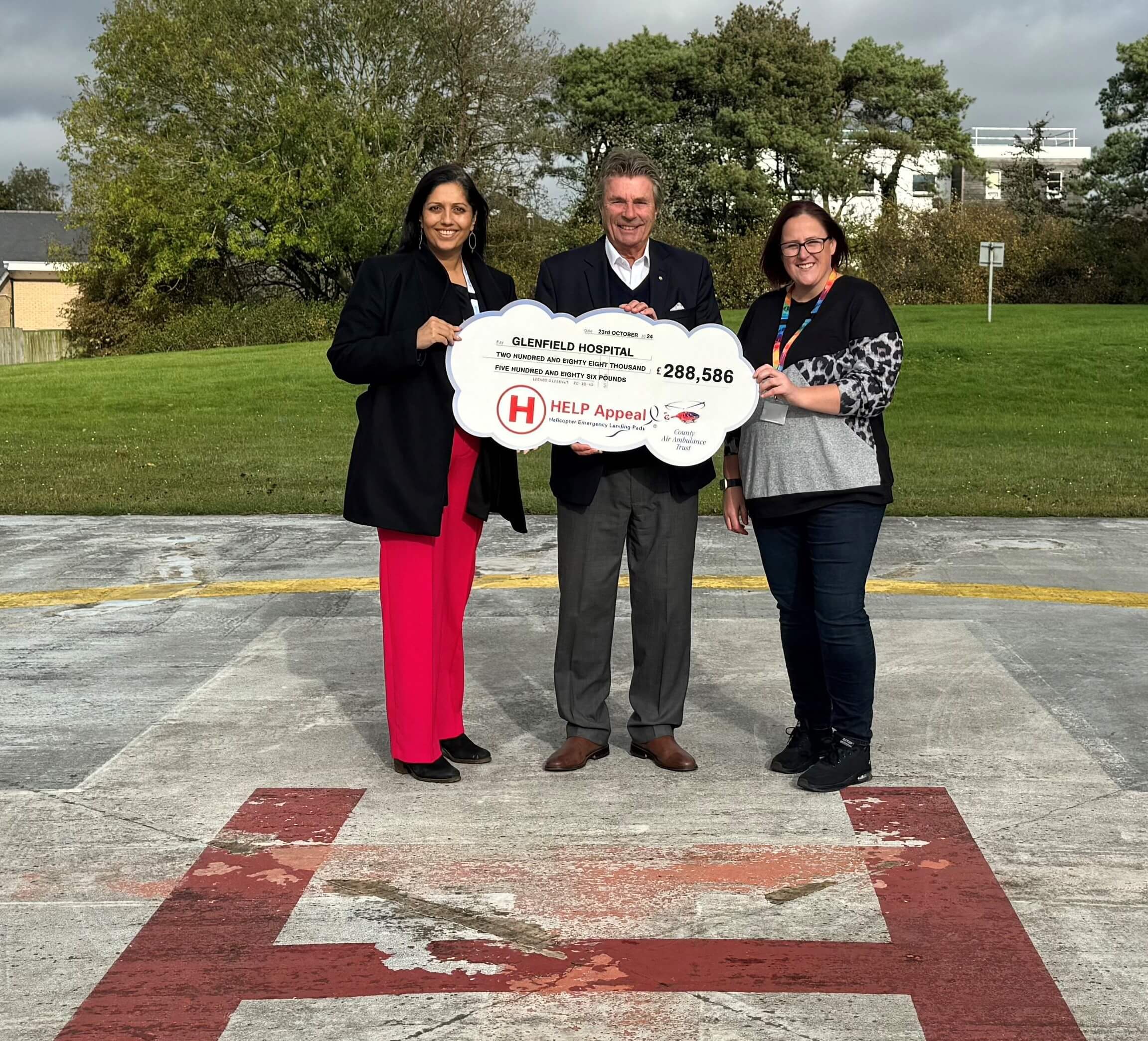 Robert Bertram, Chief Executive of the HELP Appeal, presents a cheque for £288,586 to (L) Sunita Patel, Head of Charity and (R) Grace Boughton, Capital Project Manager, University Hospitals of Leicester NHS Trust.